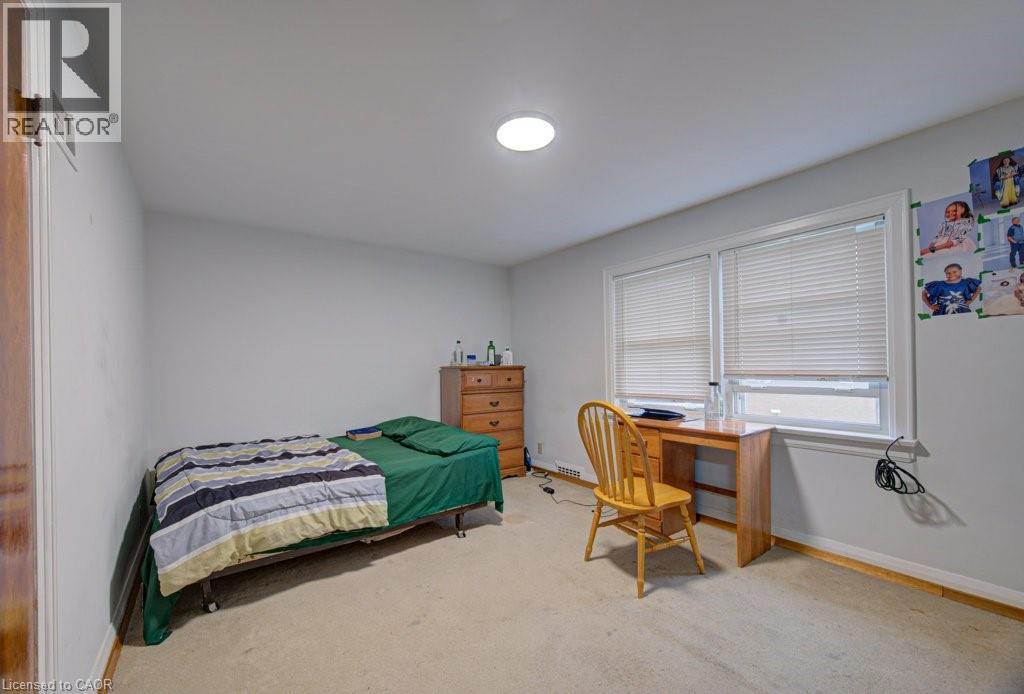 Neutral wall color with recessed ceiling lighting, light-colored carpeting, and a window with blinds - 128 Pollock Avenue, Cambridge, ON - Indoor Photo Showing Bedroom