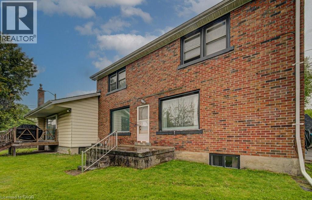 Brick exterior featuring black-framed windows and a lower-level window - 128 Pollock Avenue, Cambridge, ON - Outdoor With Exterior
