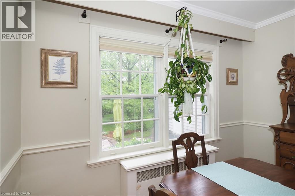 Double-hung windows with white frames and muntins, featuring a sill radiator cover - 2023 Coronation Boulevard, Cambridge, ON - Indoor
