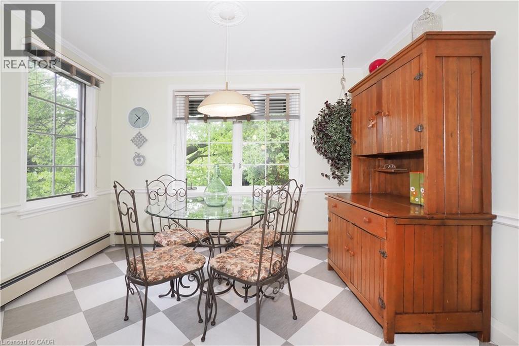 Dining area featuring a checkerboard floor, multiple windows, a ceiling medallion, and crown molding - 2023 Coronation Boulevard, Cambridge, ON - Indoor Photo Showing Dining Room
