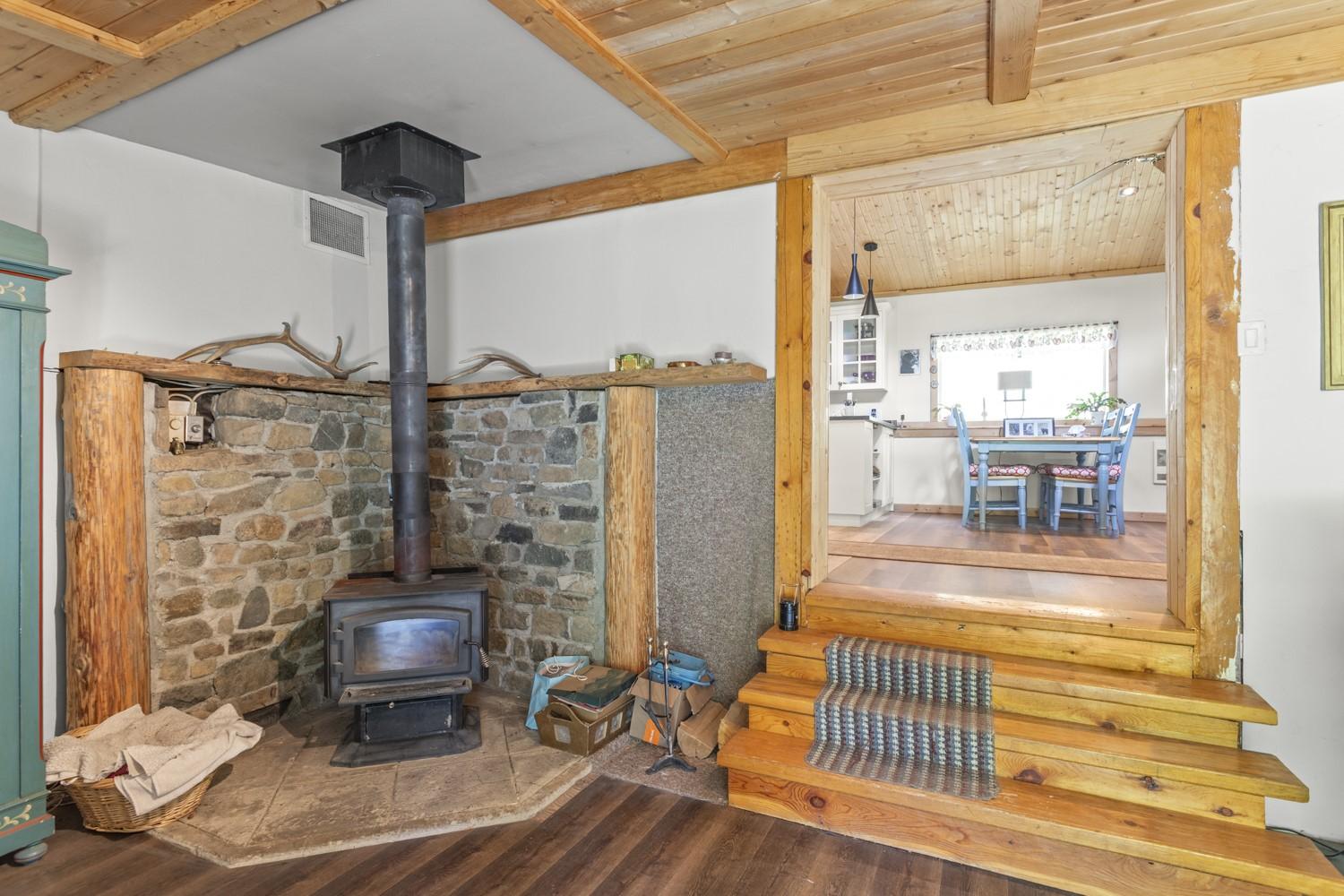 7046 Highway 3, Kitchener, BC - Indoor Photo Showing Other Room With Fireplace