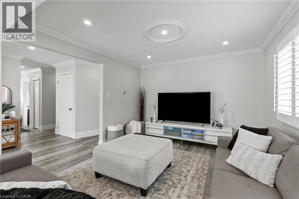 Living area featuring recessed lighting, a decorative ceiling medallion, crown molding, and wood-finish flooring - 27 Barbara Court, Hamilton, ON - Indoor Photo Showing Living Room