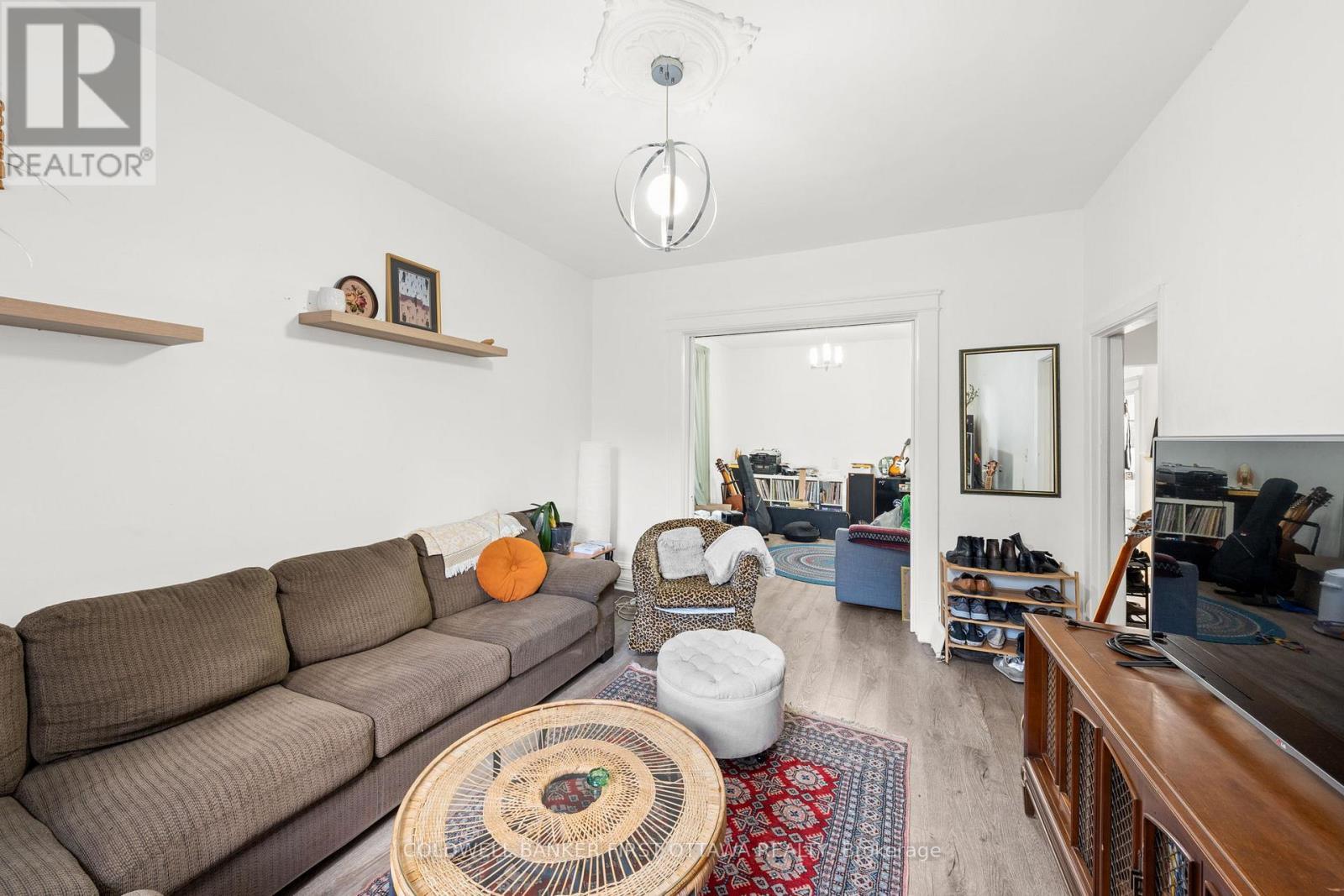 Modern fixture above, leading into dining room. - 277 Arlington Avenue, Ottawa, ON - Indoor Photo Showing Living Room