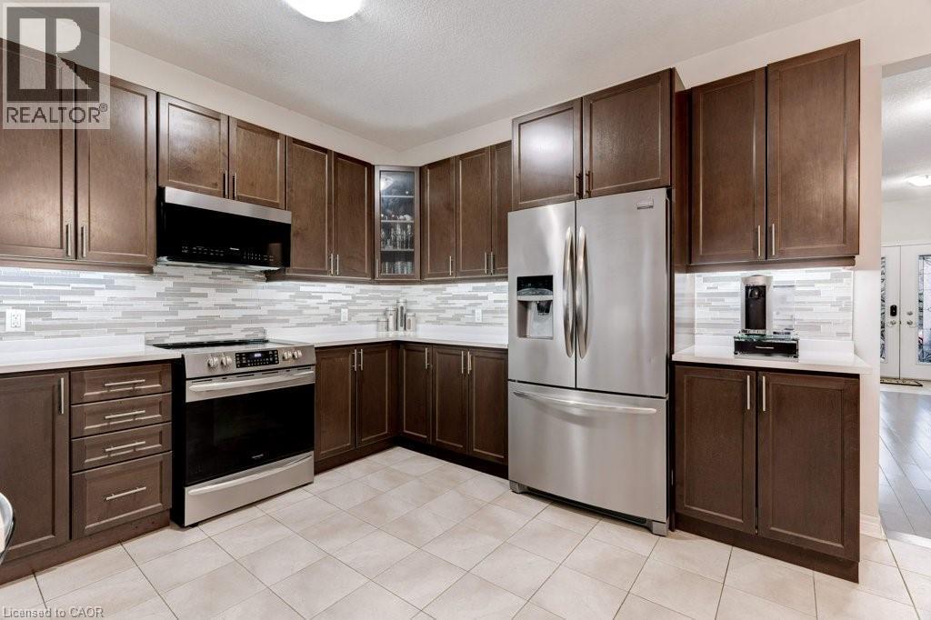 85 Showcase Drive Unit# Main, Hamilton, ON - Indoor Photo Showing Dining Room With Fireplace