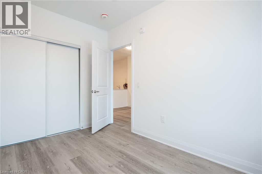 Interior room featuring light wood-finish flooring, white walls, and white trim - 1936 Rymal Road E Unit# 512, Hamilton, ON - Indoor Photo Showing Other Room