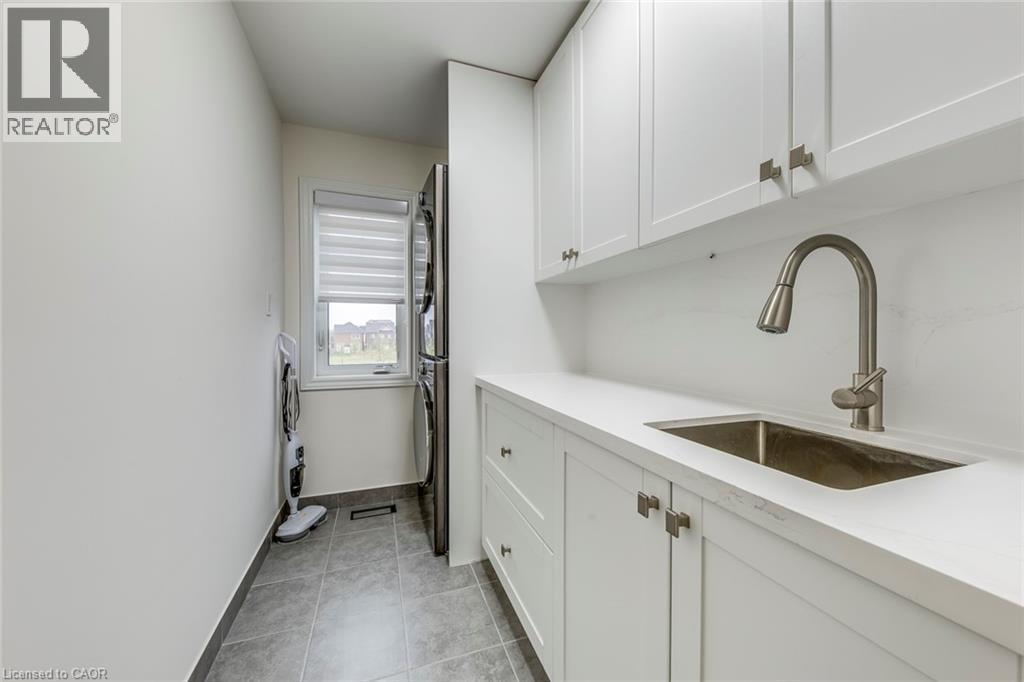 White shaker cabinetry with brushed nickel hardware, integrated sink, and gooseneck faucet - 3937 Leonardo Street, Burlington, ON - Indoor Photo Showing Kitchen