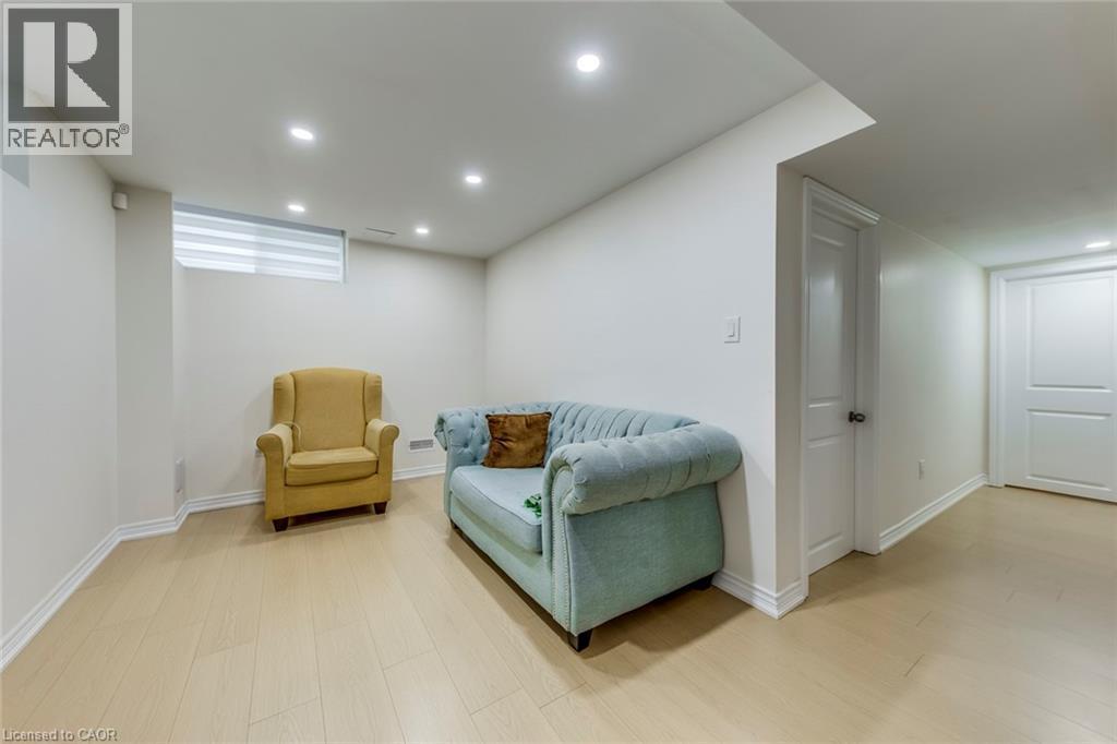 Spacious room featuring light wood-finish flooring, recessed ceiling lighting, and white baseboards - 3937 Leonardo Street, Burlington, ON - Indoor Photo Showing Basement