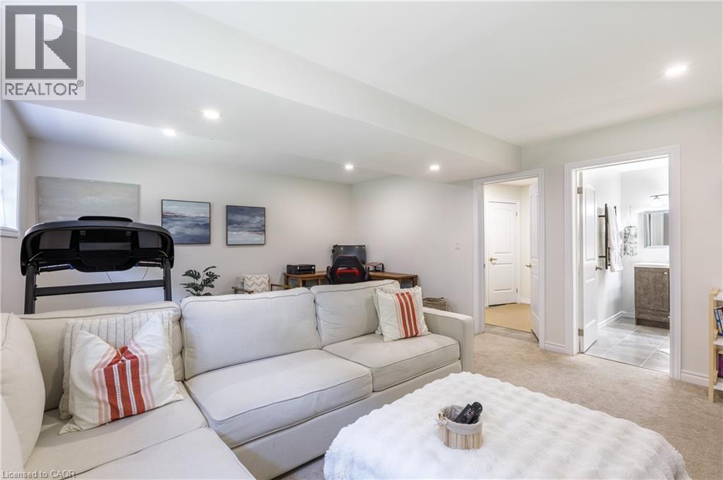 Lower level living area featuring a sectional sofa, recessed lighting, and light-colored carpeting - 10 Redbud Crescent, Simcoe, ON - Indoor Photo Showing Living Room