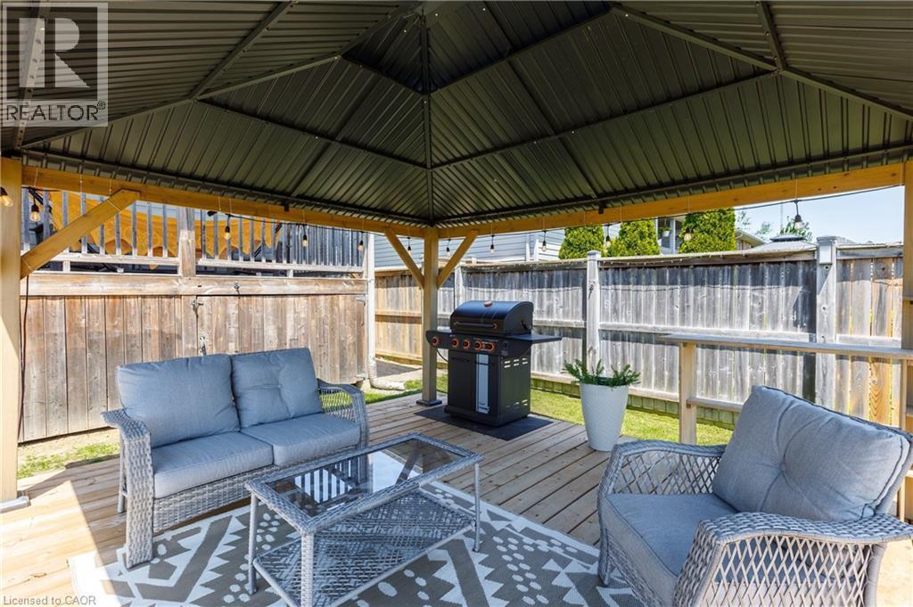 Covered outdoor living space featuring a metal gazebo roof and a wood-finish deck - 10 Redbud Crescent, Simcoe, ON - Outdoor With Deck Patio Veranda With Exterior