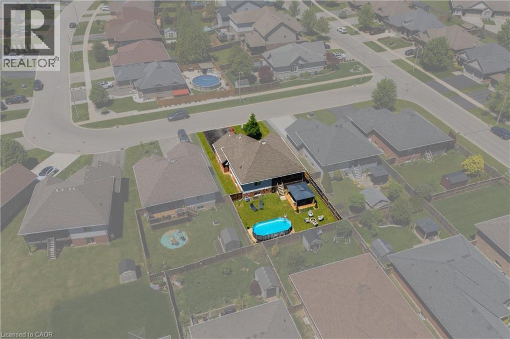 Fenced backyard featuring a gravel patio, above-ground pool, and a gazebo - 10 Redbud Crescent, Simcoe, ON - Other