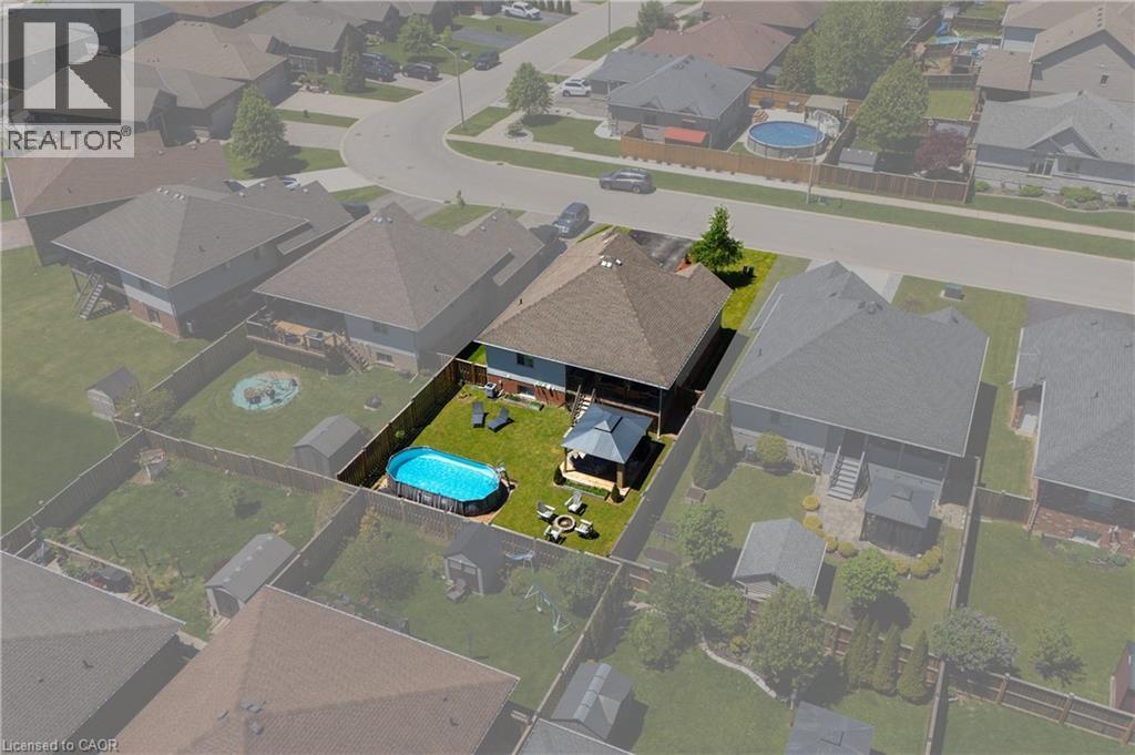 Spacious backyard featuring an above-ground pool, a covered gazebo, a stone patio, and a storage shed - 10 Redbud Crescent, Simcoe, ON - Other
