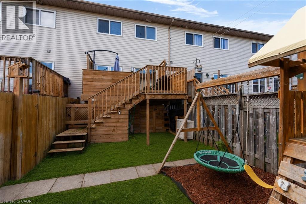 Expansive backyard featuring a multi-level wood deck, wood fencing, and a manicured lawn - 4 Parkside Crescent, Angus, ON - Outdoor With Deck Patio Veranda With Exterior
