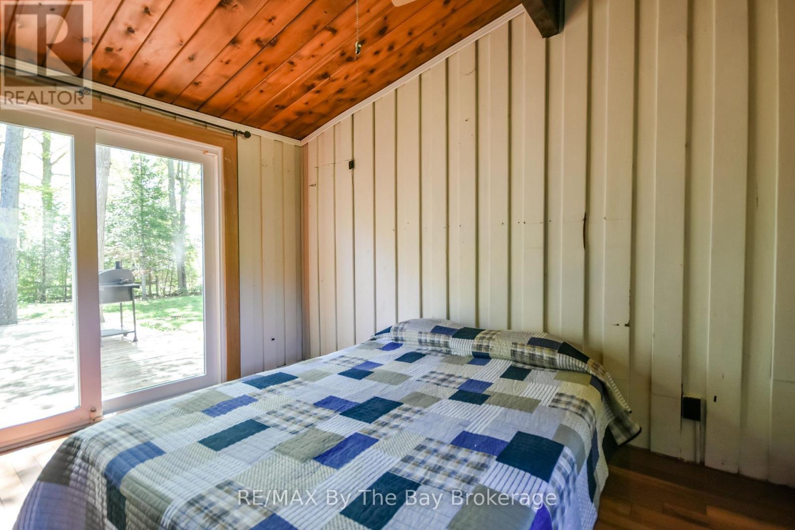 Primary Bedroom with walk-out to the deck - 22 Talon Trail, Tiny, ON - Indoor Photo Showing Bedroom