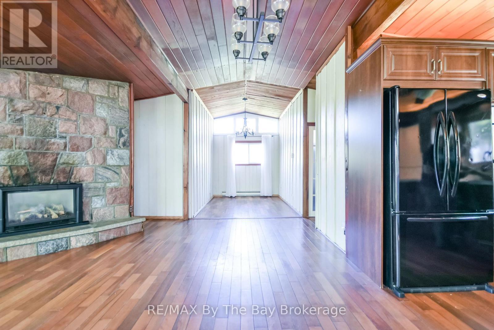 22 Talon Trail, Tiny, ON - Indoor Photo Showing Other Room With Fireplace