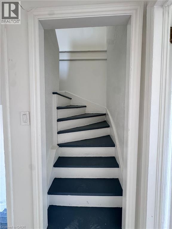 Compact interior staircase featuring dark treads and light risers - 10 Fairleigh Avenue N, Hamilton, ON - Indoor Photo Showing Other Room