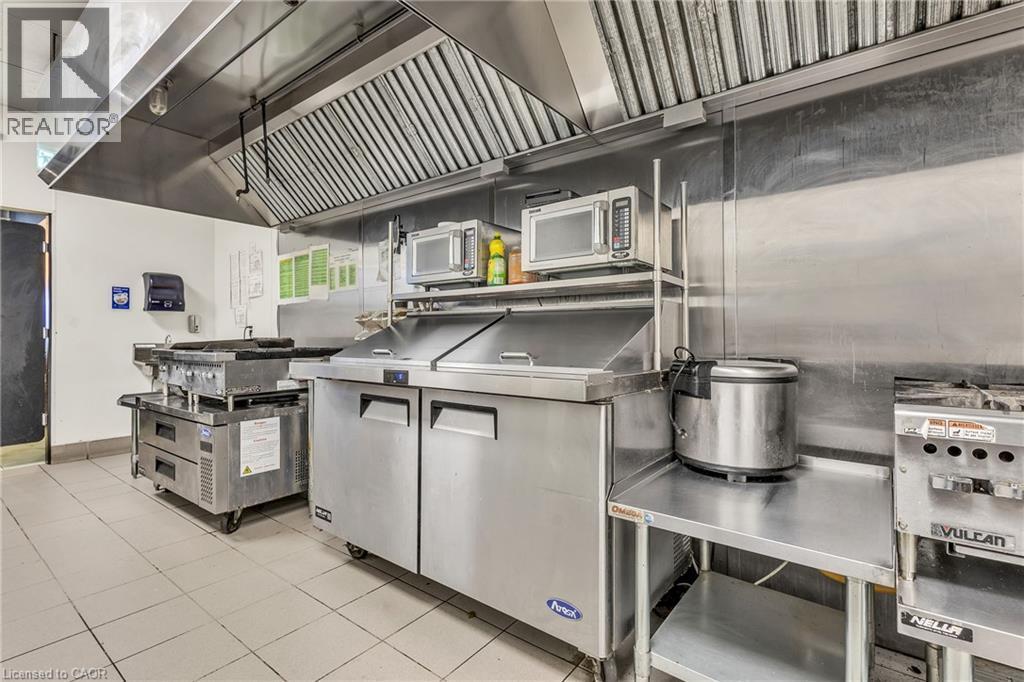 Commercial kitchen featuring stainless steel appliances and fixtures - 5 Manitou Drive Unit# 106B, Kitchener, ON