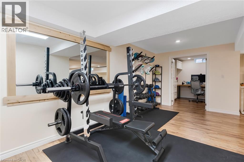 Dedicated exercise space with a full-width wall mirror framed in light-toned wood - 42 Handorf Drive, Cambridge, ON - Indoor Photo Showing Gym Room