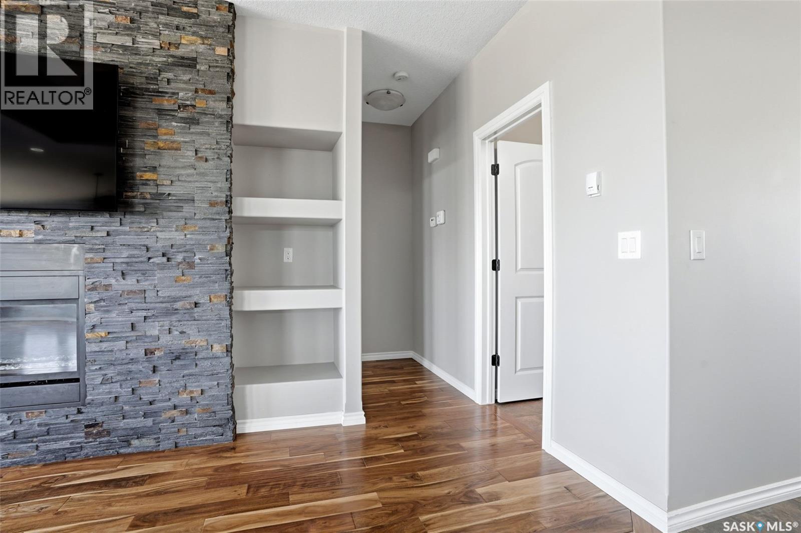 701 Saskatoon Drive, Katepwa Beach, SK - Indoor Photo Showing Other Room With Fireplace