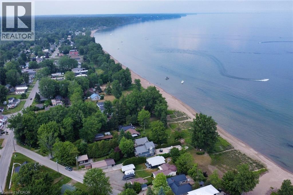 Aerial capture showcasing extensive coastline with sandy beaches and tranquil waters - 5 Ralph Street, Turkey Point, ON - Outdoor With Body Of Water With View