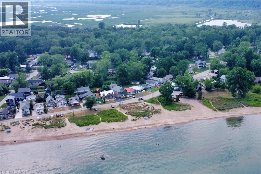 Coastal properties situated along a sandy beach with direct water access - 5 Ralph Street, Turkey Point, ON - Outdoor With Body Of Water With View