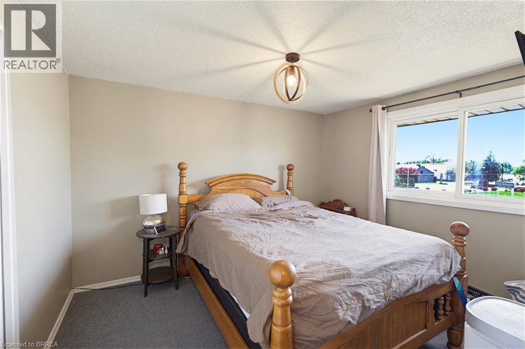 Neutral-toned walls complement the gray carpeting - 26 Coachwood Road Unit# 6, Brantford, ON - Indoor Photo Showing Bedroom