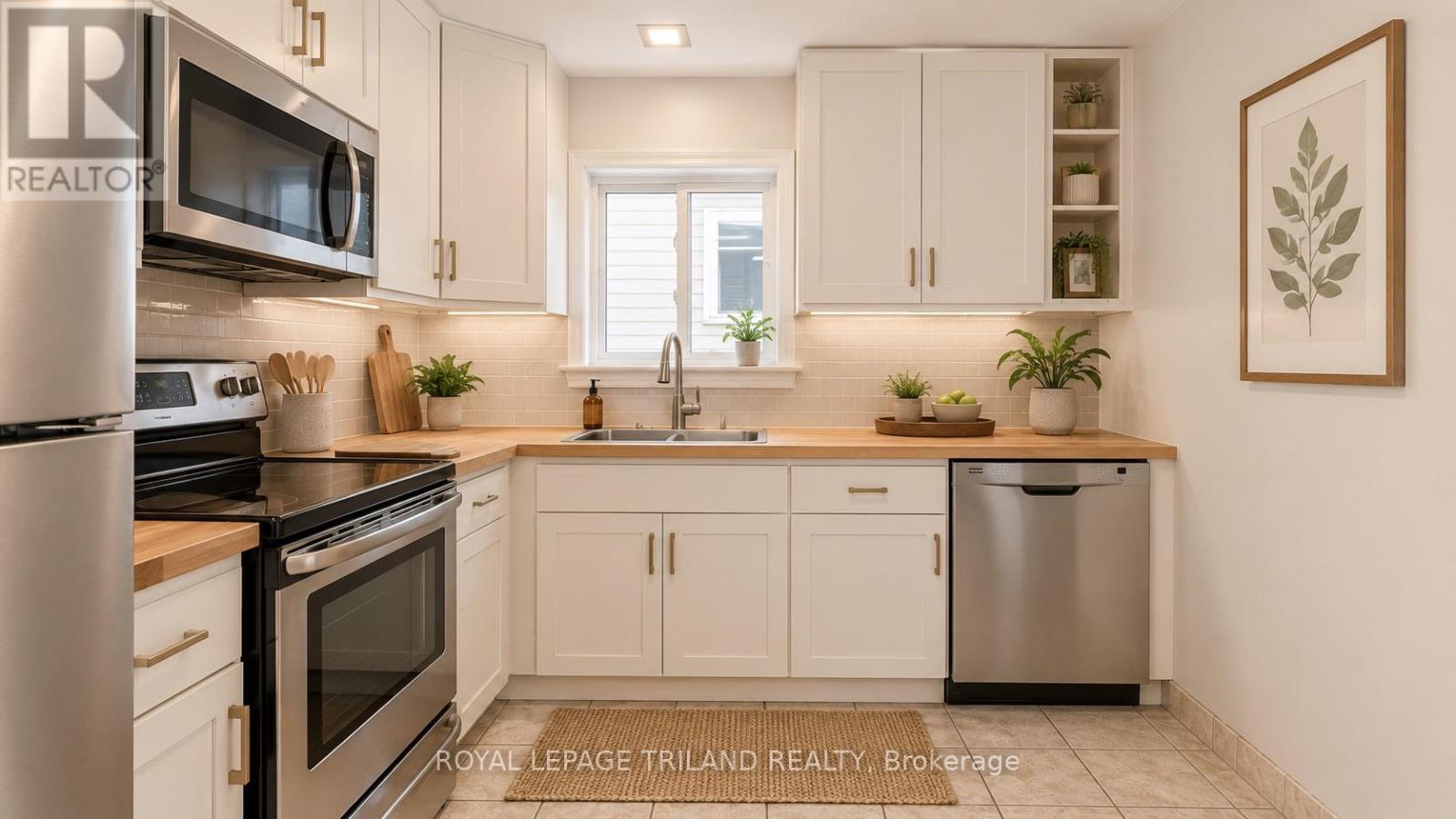 The kitchen has ample storage - 1291 Trafalgar Street, London East (East M), ON - Indoor Photo Showing Kitchen With Double Sink