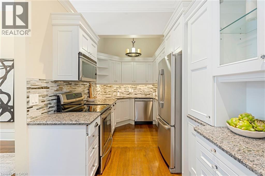 Kitchen featuring stainless steel appliances, light stone countertops, white cabinets, light wood finished floors, and open shelves - 46 Herkimer Street Unit# 2, Hamilton, ON - Indoor Photo Showing Kitchen With Stainless Steel Kitchen With Upgraded Kitchen