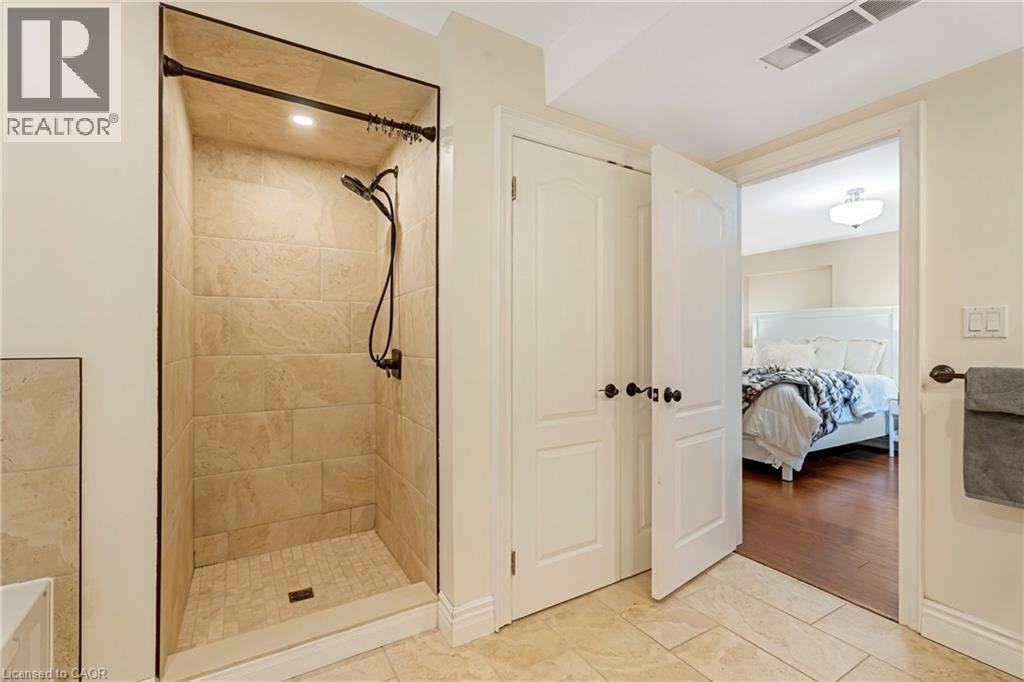 Ensuite bathroom with a shower stall and light tile patterned floors - 46 Herkimer Street Unit# 2, Hamilton, ON - Indoor Photo Showing Bathroom