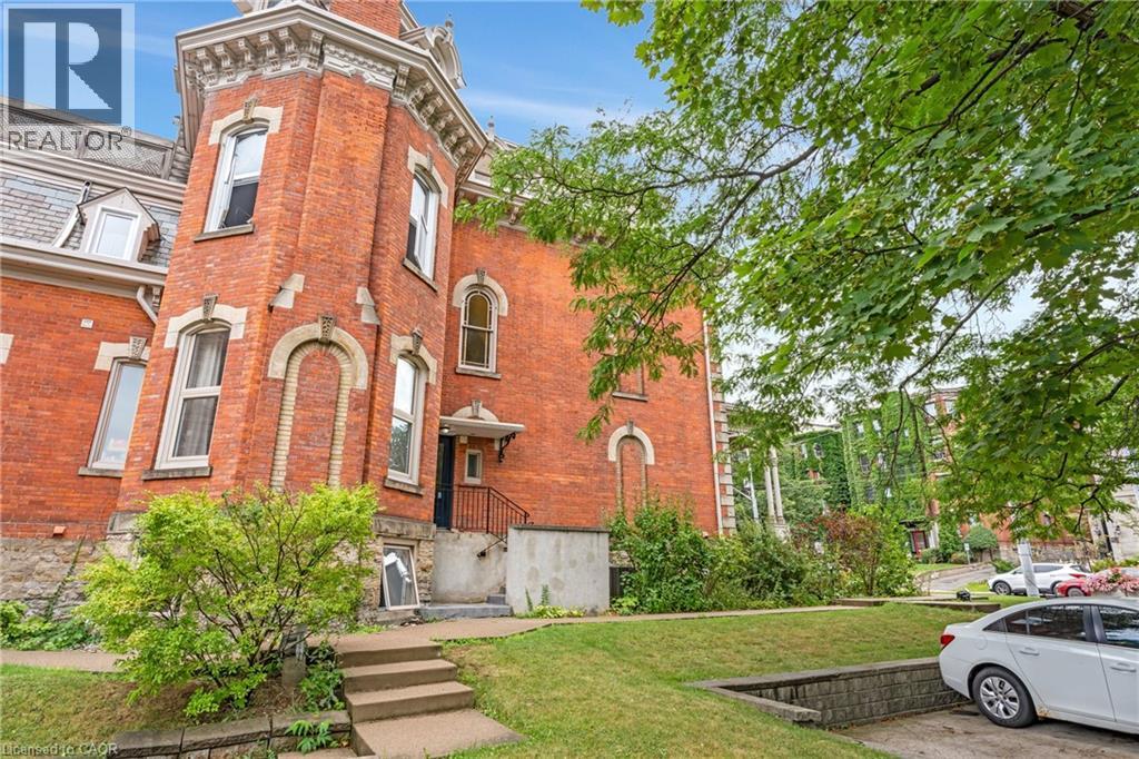 View of front of property with a front yard and brick siding - 46 Herkimer Street Unit# 2, Hamilton, ON - Outdoor