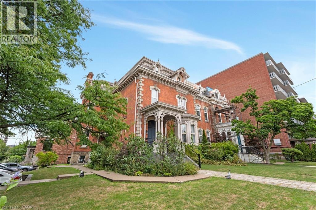 View of front of property featuring brick siding and a front lawn - 46 Herkimer Street Unit# 2, Hamilton, ON - Outdoor