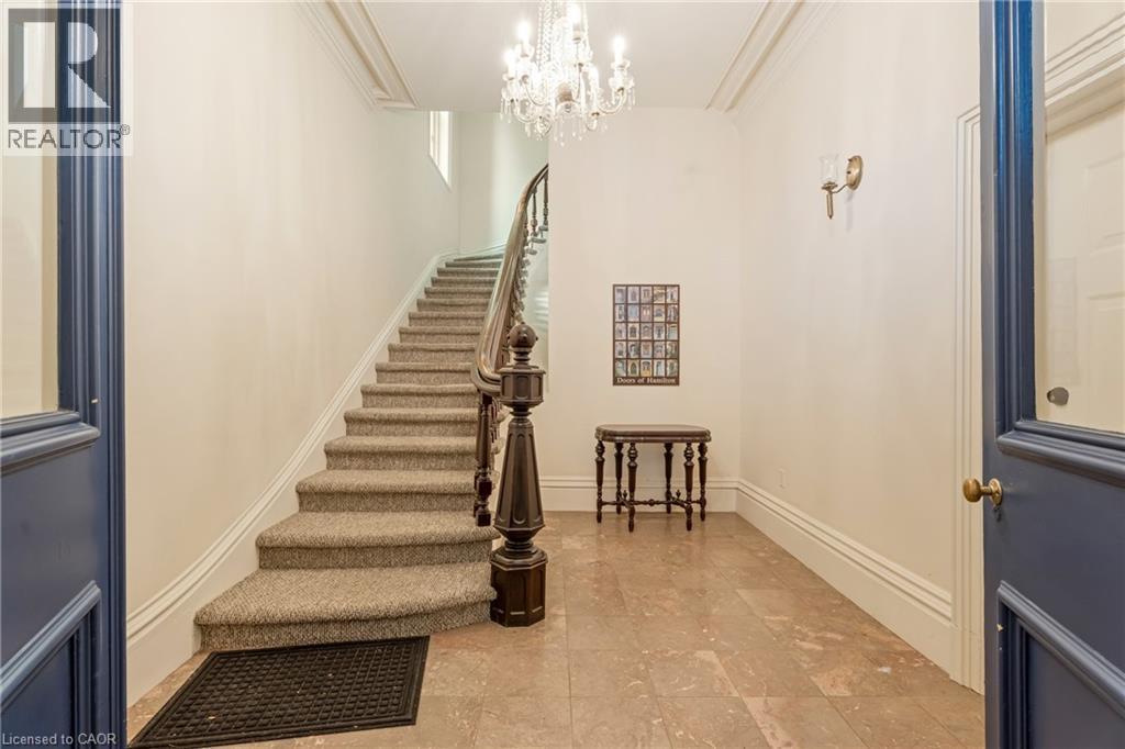 Staircase featuring a chandelier and crown molding - 46 Herkimer Street Unit# 2, Hamilton, ON - Indoor Photo Showing Other Room