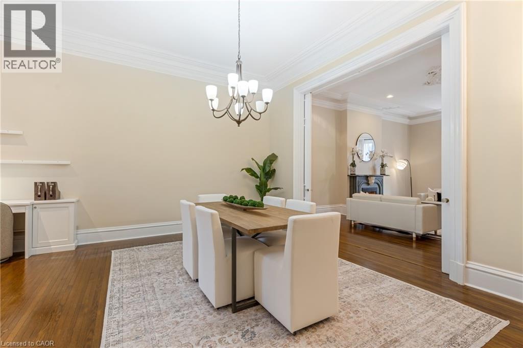 Dining space featuring ornamental molding, dark wood finished floors, and a chandelier - 46 Herkimer Street Unit# 2, Hamilton, ON - Indoor Photo Showing Other Room