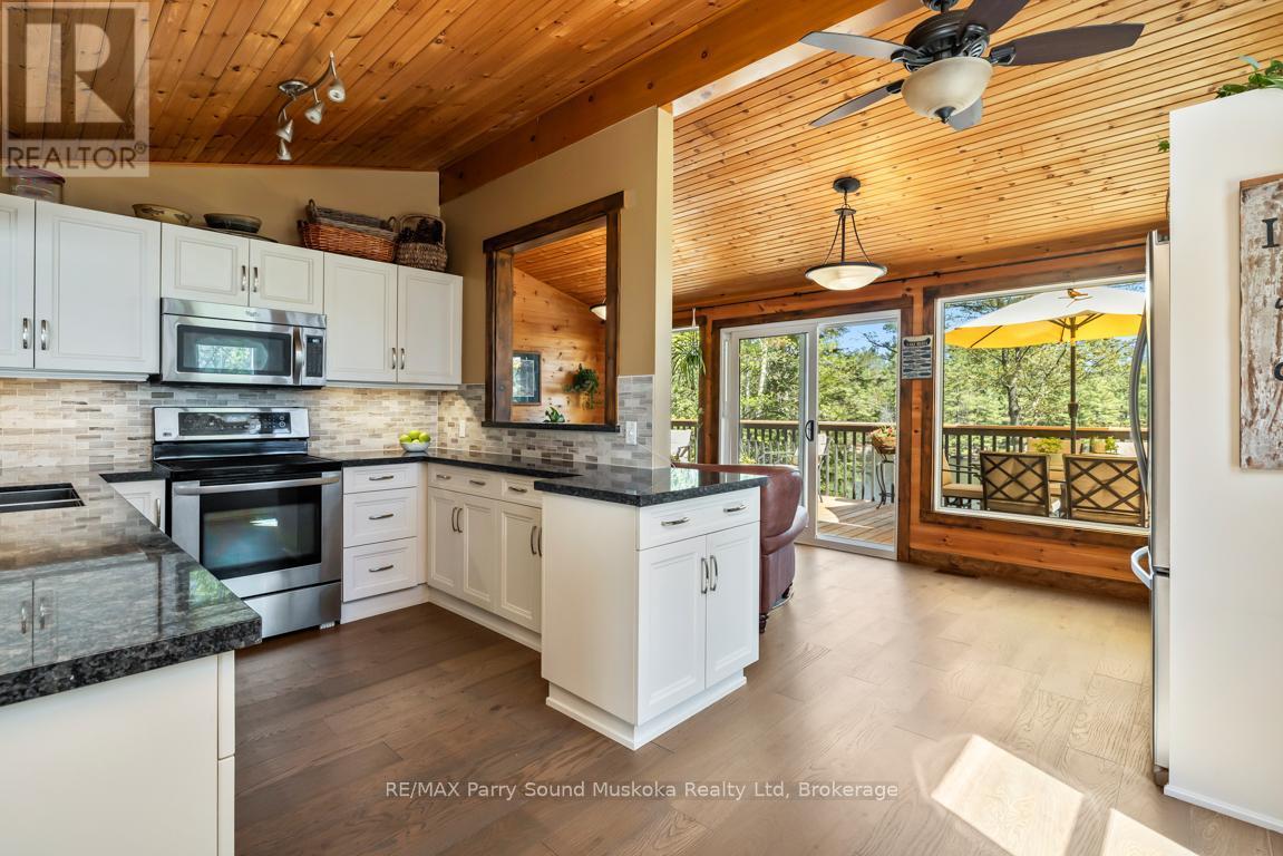 Walkout to lakeside deck - 13 Peninsula Shores Road E, Mcdougall, ON - Indoor Photo Showing Kitchen With Upgraded Kitchen