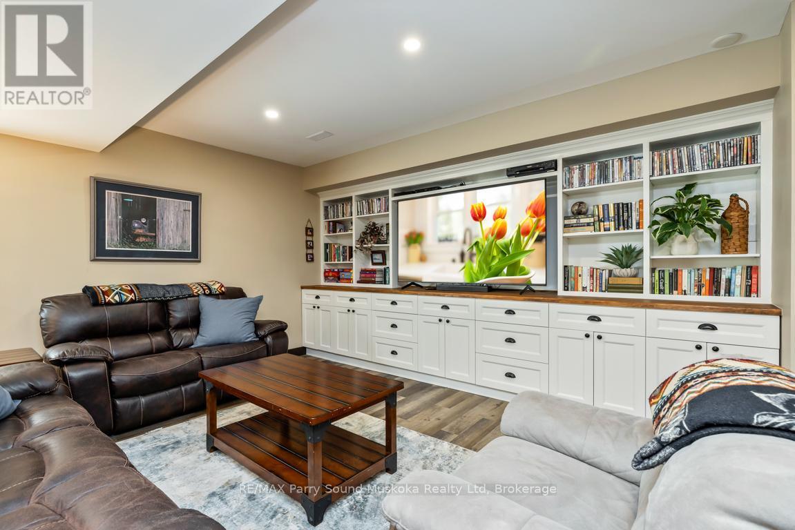 Family room w built in cabinetry - 13 Peninsula Shores Road E, Mcdougall, ON - Indoor Photo Showing Living Room
