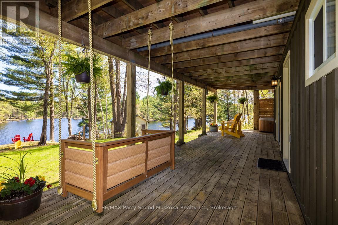 Swing your cares away - 13 Peninsula Shores Road E, Mcdougall, ON - Outdoor With Body Of Water With Deck Patio Veranda With Exterior