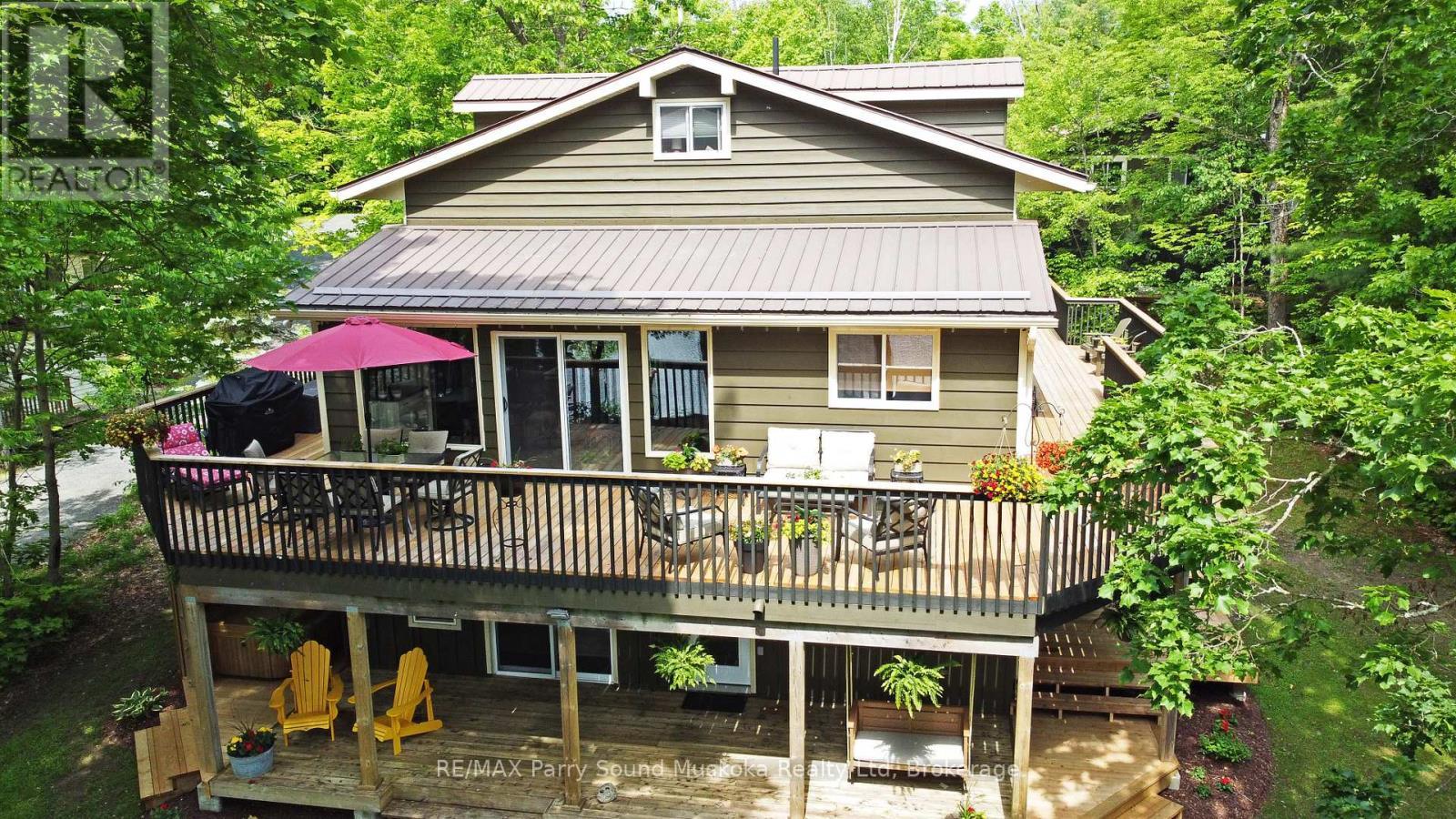 Wrap around decking - 13 Peninsula Shores Road E, Mcdougall, ON - Outdoor With Deck Patio Veranda