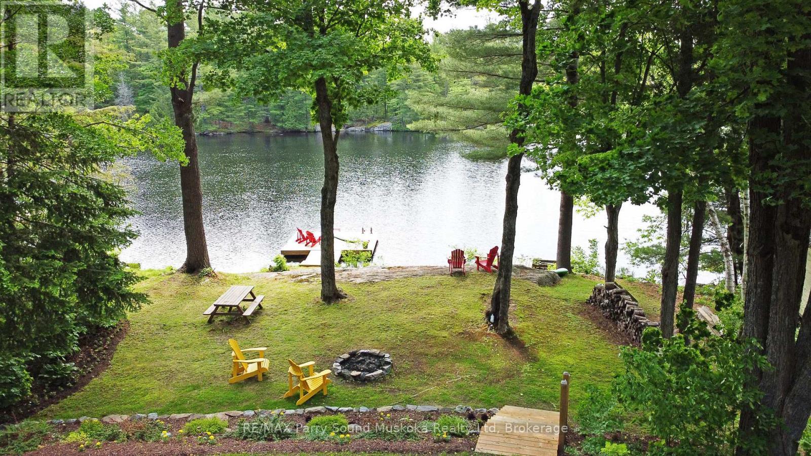 Private treed .558 acre lot - 13 Peninsula Shores Road E, Mcdougall, ON - Outdoor With Body Of Water