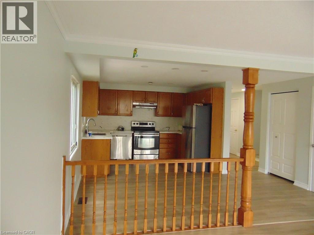 Kitchen featuring wood-finish cabinetry, stainless steel appliances, recessed lighting, and a window - 90 Bridlewreath Street Unit# Upper Unit, Kitchener, ON - Indoor Photo Showing Other Room