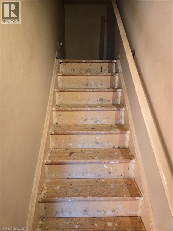 Staircase featuring wood treads and risers, with a light-toned handrail - 95 Fonthill Road Unit# 2, Hamilton, ON - Indoor Photo Showing Other Room