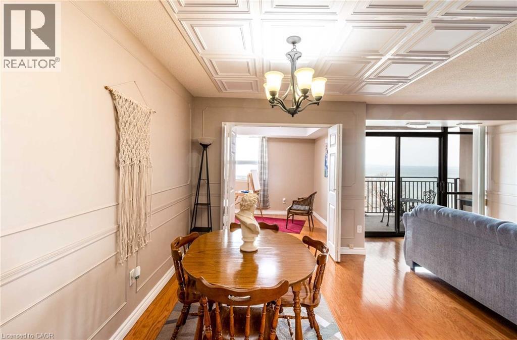 Dining area with coffered ceiling and wood-finish flooring - 500 Green Road Unit# 901, Stoney Creek, ON - Indoor Photo Showing Dining Room