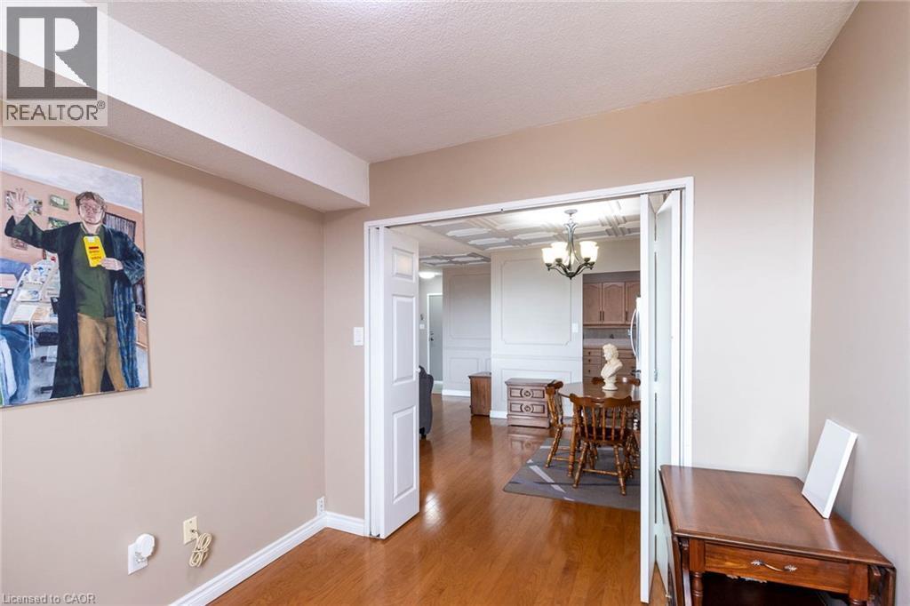 Hardwood-finish flooring throughout, featuring a broad doorway providing access to additional rooms - 500 Green Road Unit# 901, Stoney Creek, ON - Indoor
