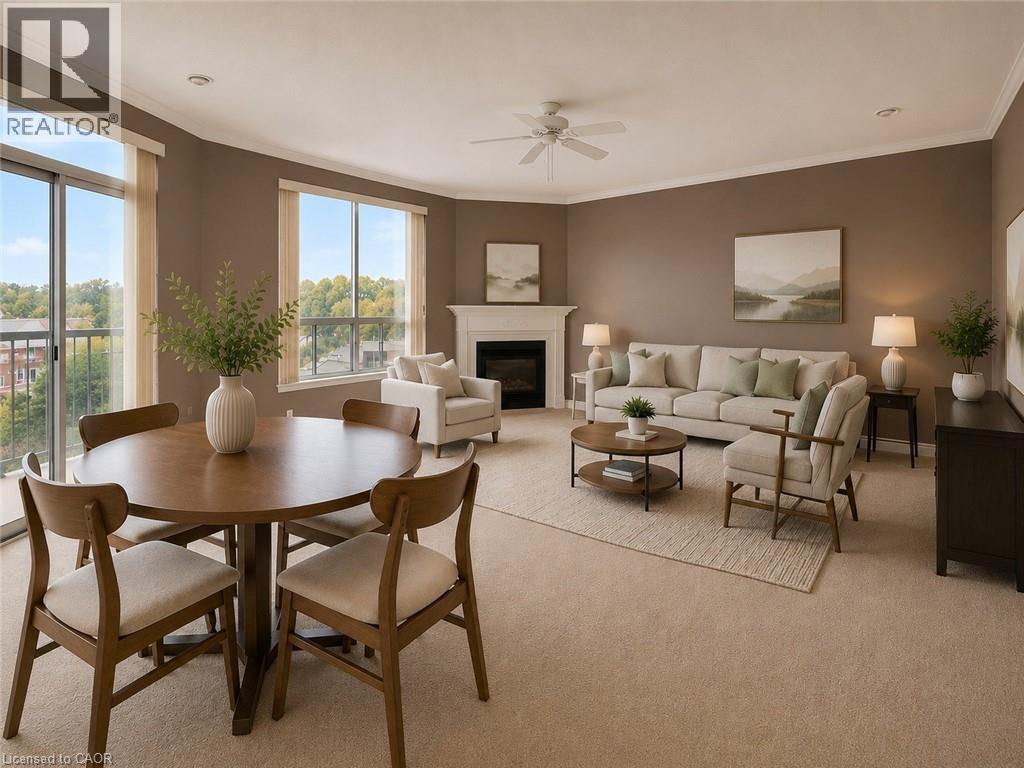Spacious living area featuring neutral carpet flooring and crown molding - 255 Keats Way Unit# 606, Waterloo, ON - Indoor With Fireplace