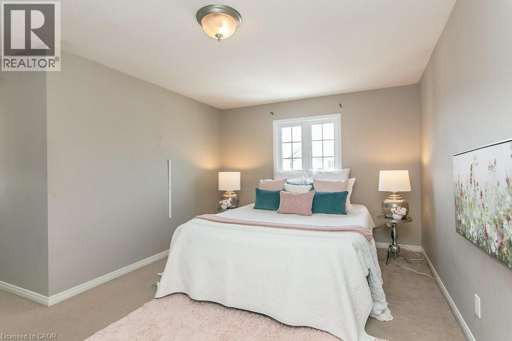 Carpeted room featuring a double-paned window, a flush-mount ceiling light fixture, and neutral-toned walls - 71 Foxglove Crescent, Kitchener, ON - Indoor Photo Showing Bedroom