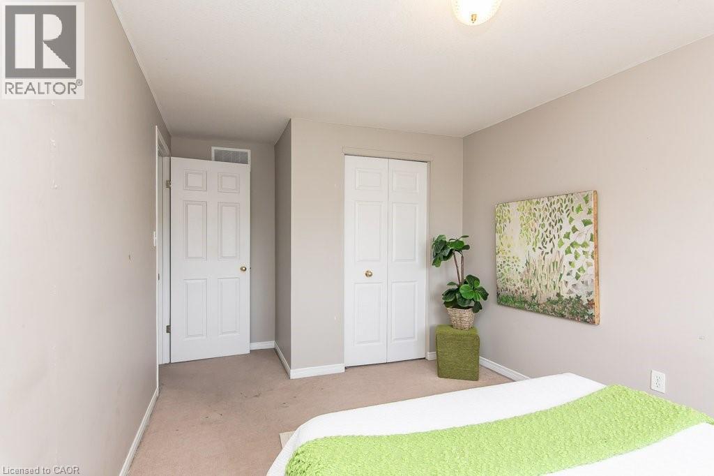 Neutral-toned walls complement the carpeted flooring - 71 Foxglove Crescent, Kitchener, ON - Indoor Photo Showing Bedroom