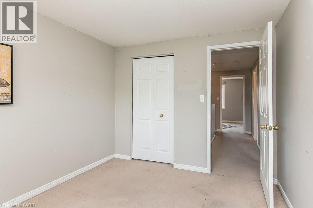 Carpeted room with light neutral wall paint - 71 Foxglove Crescent, Kitchener, ON - Indoor Photo Showing Other Room