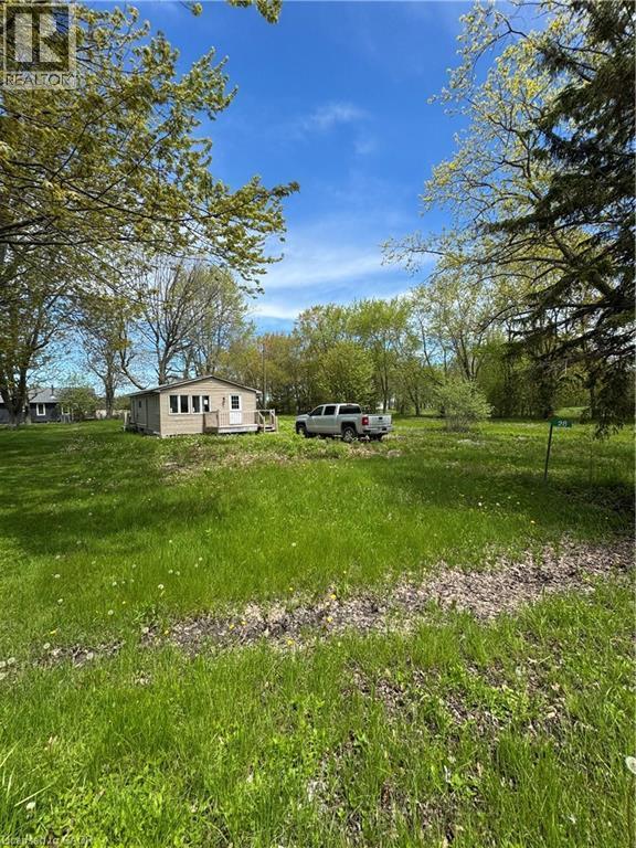 Single-story residence featuring light-toned siding and multiple windows - 28 Derner Line, Lowbanks, ON - Outdoor With View