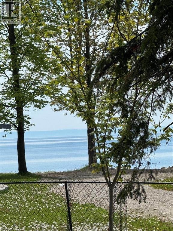 Waterview property featuring mature trees and a chain-link fence - 28 Derner Line, Lowbanks, ON - Outdoor With View