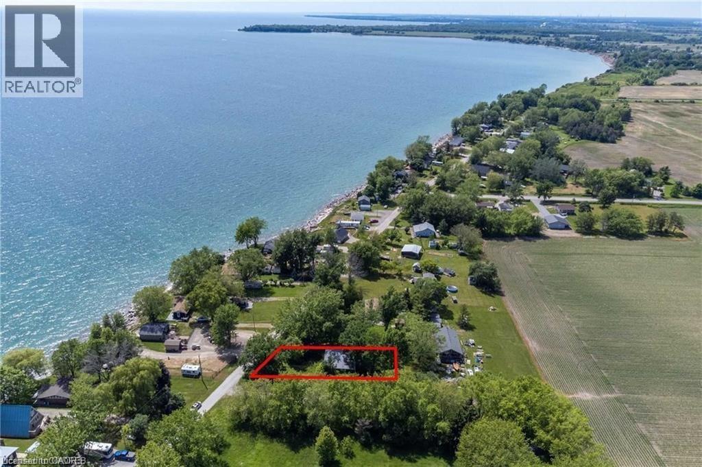 Aerial perspective showcasing a property with waterfront access, surrounded by mature trees - 28 Derner Line, Lowbanks, ON - Outdoor With Body Of Water With View