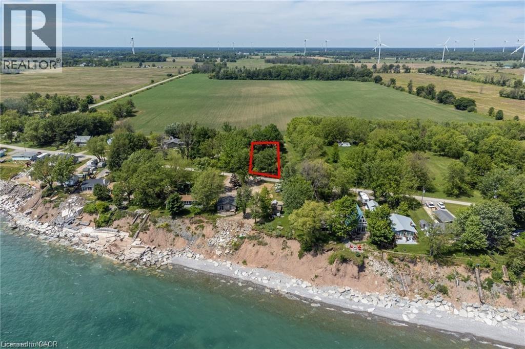 Elevated waterfront parcel featuring mature trees, a rocky shoreline, and expansive agricultural fields - 28 Derner Line, Lowbanks, ON - Outdoor With Body Of Water With View