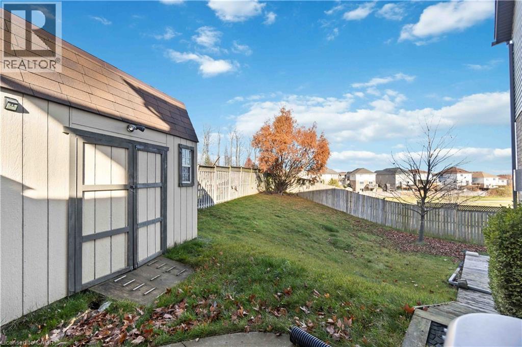 Exterior storage shed featuring a gambrel roof and double doors - 27 Red Clover Crescent, Kitchener, ON - Outdoor